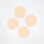 Set of 4 natural leather coasters stamped with frowny face and smiley faces